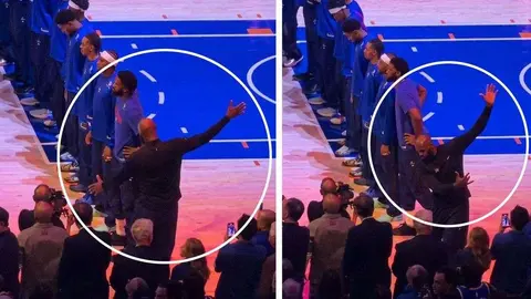 LeBron James ulusal marş sırasında ısınma hareketi yaparken, arka planda basketbol sahası