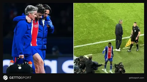 PSJ forması ilə zədələnmiş futbolçu və stadion fonu